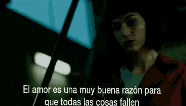 a woman in a dark room with the words el amor es una muy buena razon para que todas las cosas fallen on the bottom