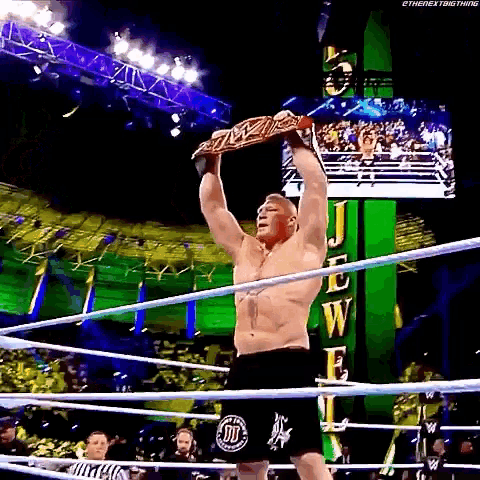 a man in a wrestling ring is holding a wwe championship belt over his head .