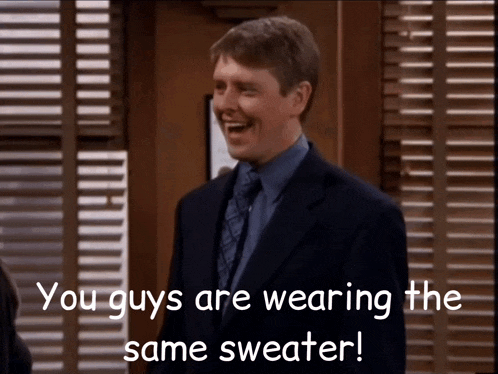 a man in a suit and tie is laughing with the words you guys are wearing the same sweater