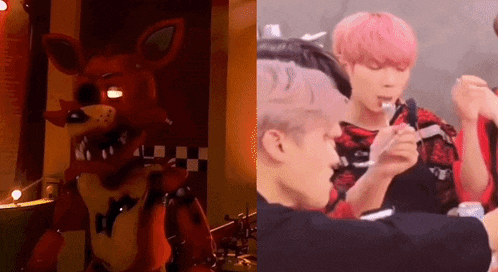 a fox from five nights at freddy 's is standing next to a man with pink hair eating a sandwich .