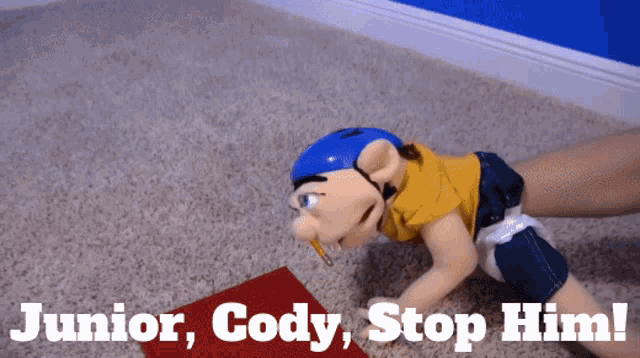 a puppet is crawling on the floor with the words junior cody stop him below it