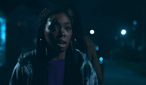 a man with dreadlocks is standing next to a woman with a surprised look on her face