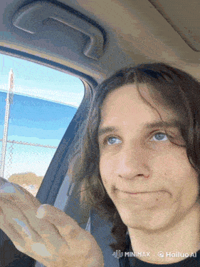 a young man is sitting in a car with a watermark that says hailuo ai