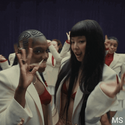 a group of women are dancing and the word ms is on the bottom left
