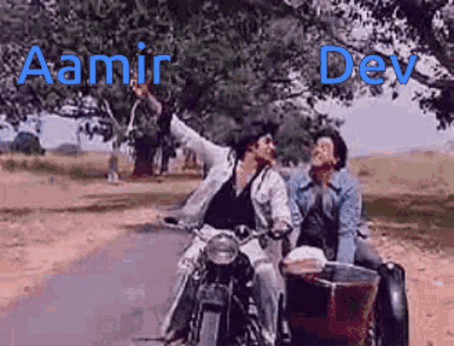 two men are riding a motorcycle on a dirt road with the name aamir dev on the bottom right