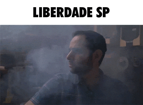 a man in a plaid shirt is surrounded by smoke and the words liberdade sp