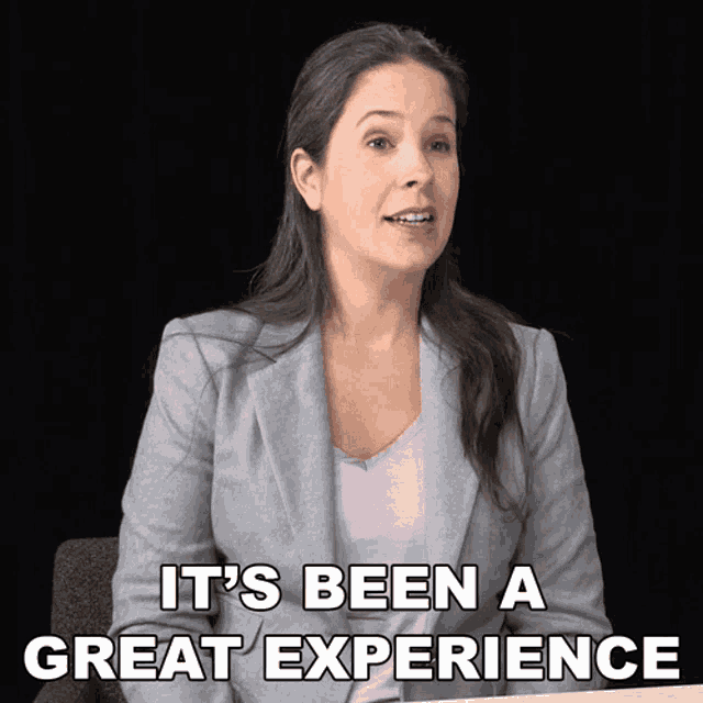 a woman in a grey jacket says " it 's been a great experience "