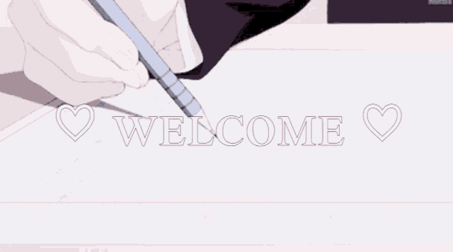 a person writing on a piece of paper with the words welcome written in white