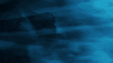 a robot is surrounded by smoke in a dark room