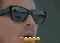 a close up of a man wearing sunglasses with emojis on his face .
