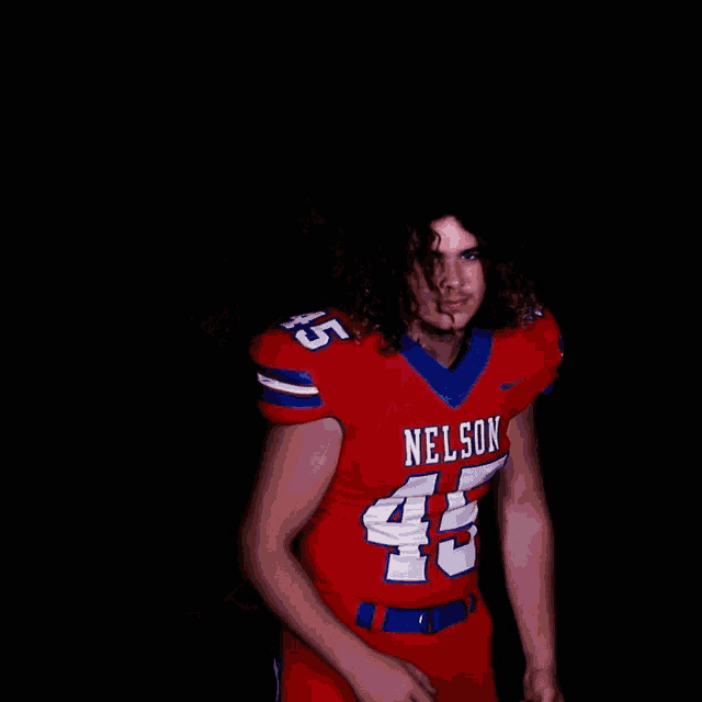 a football player wearing a red nelson jersey