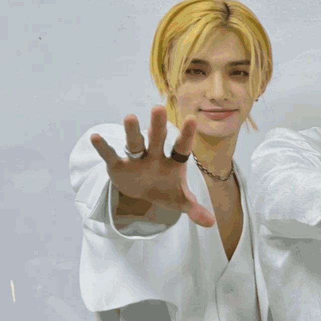 a hand is reaching out towards a smiley face