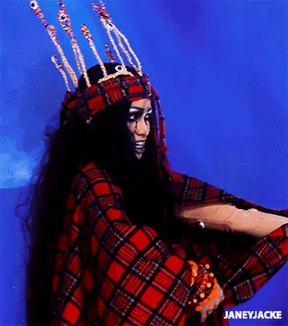 a woman wearing a plaid shirt and a crown has the name janeyjacke on the bottom right