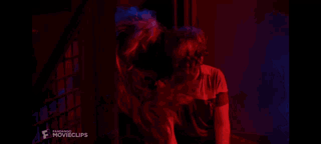 a man in a red shirt is in a movie clip from a movie called paranormal movieclips
