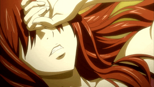 a close up of a woman with red hair covering her face