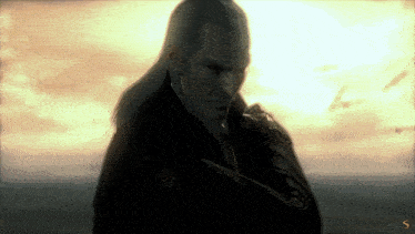 a man with long hair and a mustache is holding a knife in front of a cloudy sky
