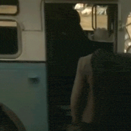 a man in a cowboy hat is getting on a bus .