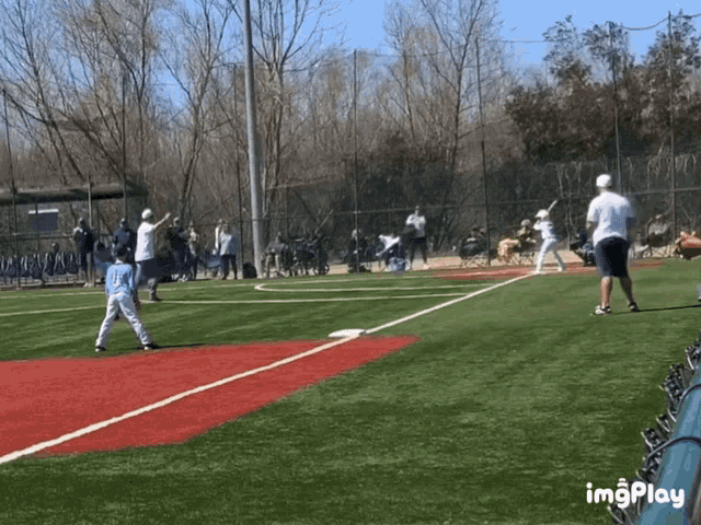 a baseball game is being played on a field with the word imgplay at the bottom of the screen