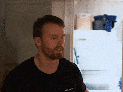 a man with a beard is wearing a black champion t-shirt