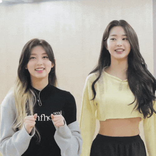 two girls are standing next to each other and one has a shirt that says seoul