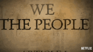 a sign that says " we the people " on a brown background