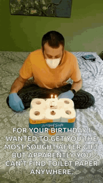 a man wearing a mask and gloves is sitting on a bed surrounded by toilet paper rolls and a candle .