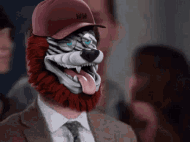 a man in a suit and tie with a tiger mask on his head