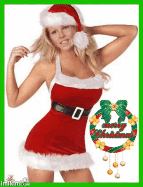 a woman in a santa costume with a merry christmas wreath