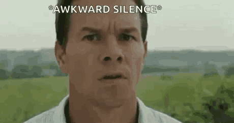 a close up of a man 's face with the words `` awkward silence '' written on the bottom .