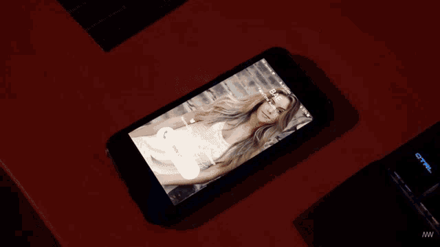 a phone displays a picture of a woman on the screen