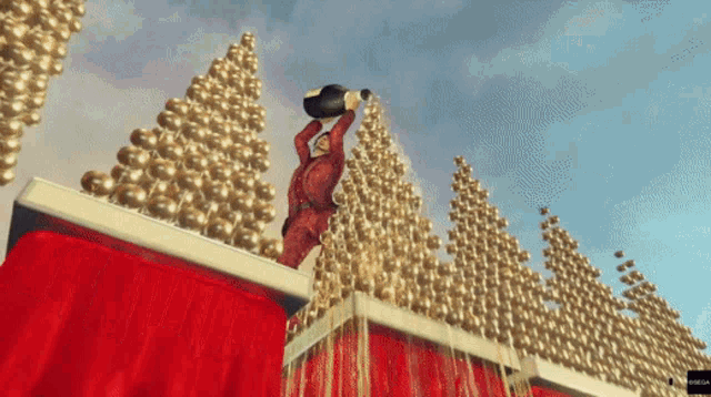 a man is pouring a bottle of champagne on top of a red box