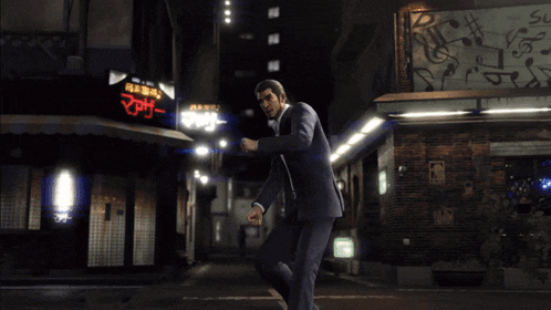 a man in a suit is standing in front of a sign that says yahoo