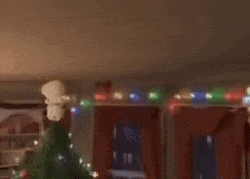 a stuffed animal is hanging from the ceiling in a living room with its mouth open .