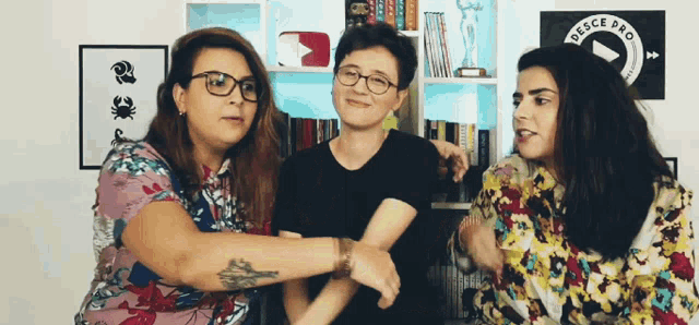 three women are standing next to each other in front of a sign that says ' desce pro ' on it