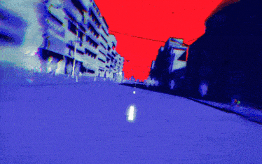 a computer generated image of a city street with a red sky in the background