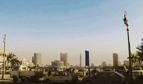 a busy city street with a blue sign that says ' a '