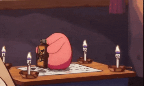 a pink bunny rabbit is standing on a table with candles .