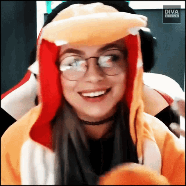 a woman wearing glasses and a hat with diva on the bottom right