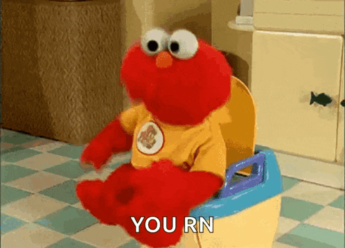 elmo is sitting on a potty with the words `` you rn '' written on it .