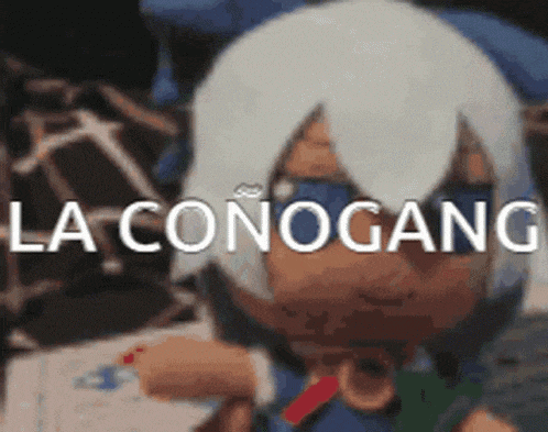 a doll with white hair is sitting on a table with the words la conogang written on it .
