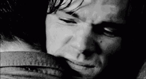 a close up of a person 's face in a black and white photo with their eyes closed .