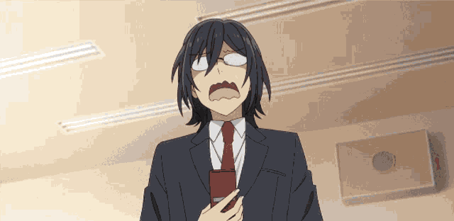 a man in a suit and tie has his mouth wide open