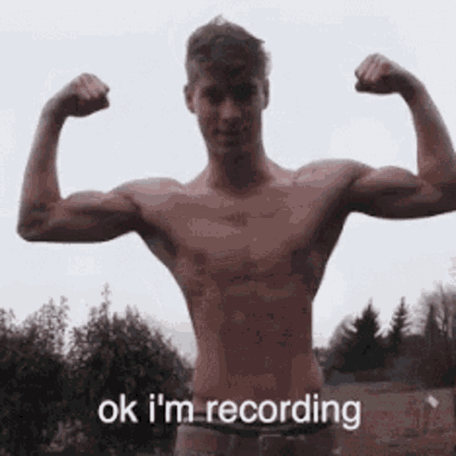 a shirtless man is flexing his muscles and says ok i 'm recording