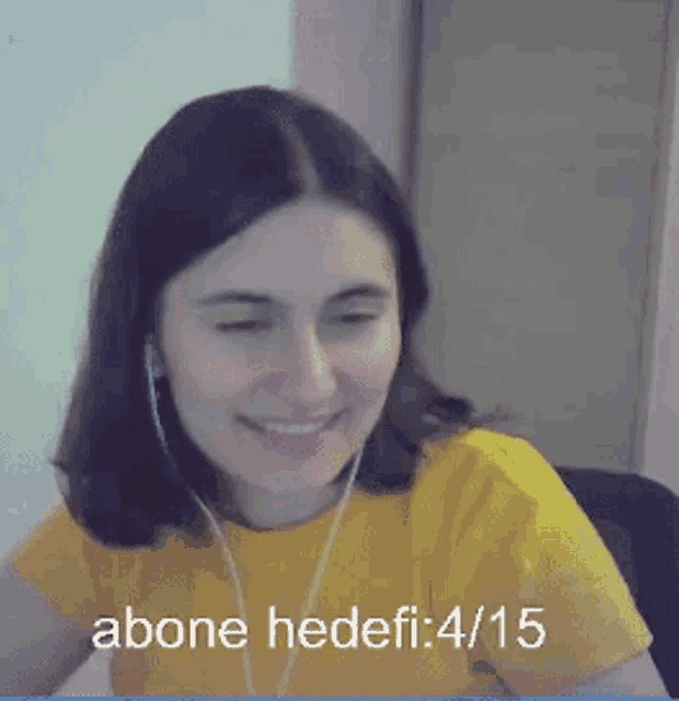 a woman wearing headphones and a yellow shirt says " abone hedefi : 4/15 " on the bottom