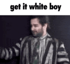 a man in a striped jacket and tie is standing in front of a black background and says `` get it white boy '' .