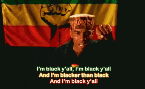 a man holding a drum in front of a flag that says ' i 'm black y 'all '