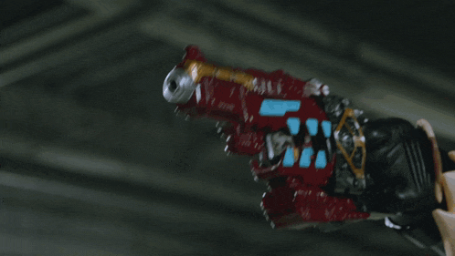 a blurred image of a gun with a flame coming out of the barrel
