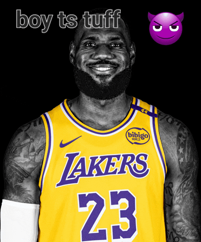 a man wearing a yellow lakers jersey with the number 23 on it