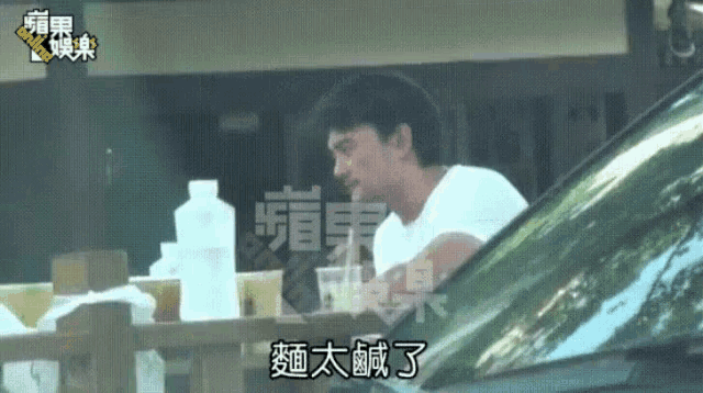 a man is sitting in the driver 's seat of a car eating food .