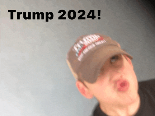 a man wearing a hat that says trump 2024 makes a funny face